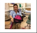 Healthcare support worker explains benefits of scalp cooling for cancer patients