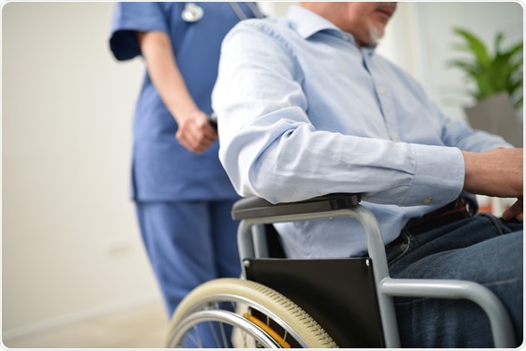 Nurse pushing an injured patient on a wheelchair - Image Copyright: Minerva Studio / Shutterstock
