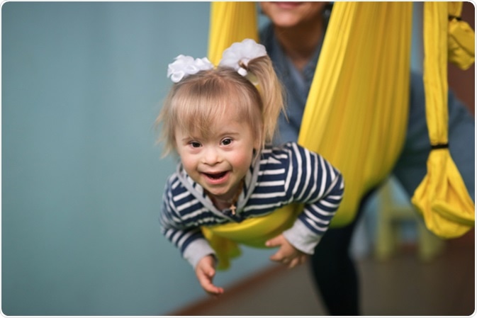 Mom with child Down syndrome playing. Image Credit: Natalia Lebedinskaia / Shutterstock