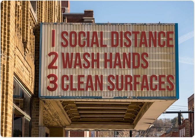 Movie cinema billboard with three basic rules to avoid the coronavirus or Covid-19 epidemic of wash hands, maintain social distance and clean surfaces. Image Credit: Steve Heap / Shutterstock