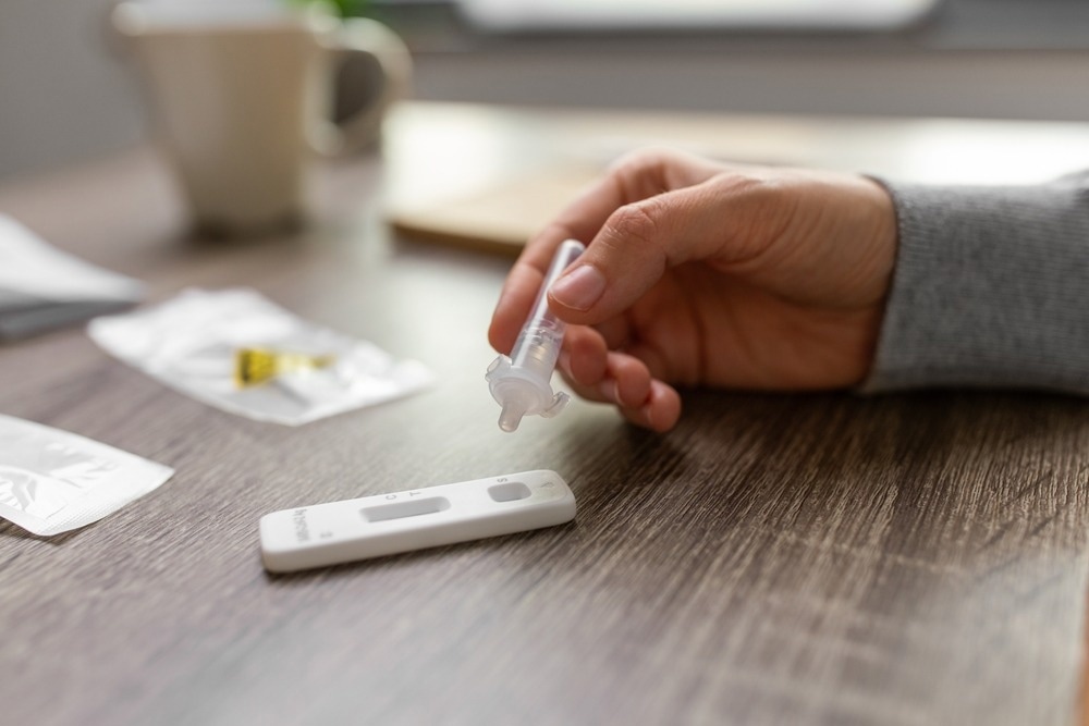 Close up of woman making self testing coronavirus test at home