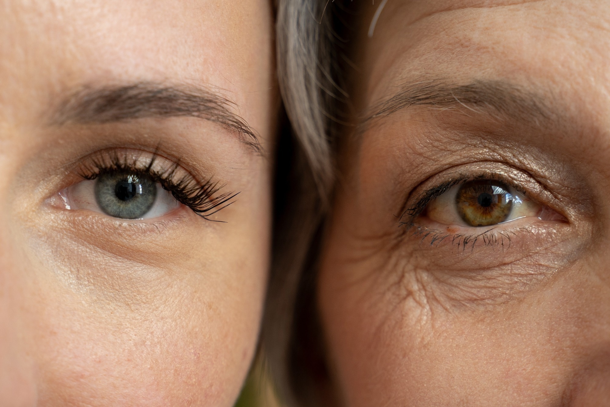 A close-up comparison of the eyes of a young woman and an older woman, highlighting the visible differences in skin texture and wrinkles.