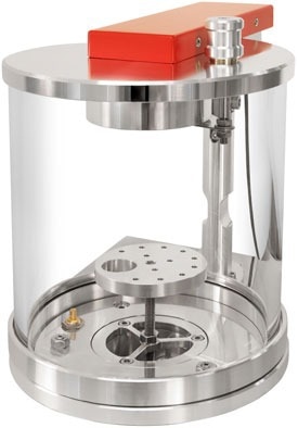 Stationary stage with tall glass chamber.