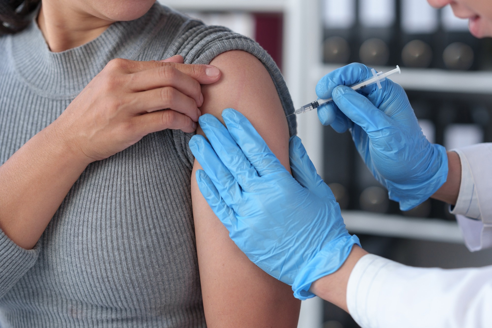 woman receives flu vaccine at hospital